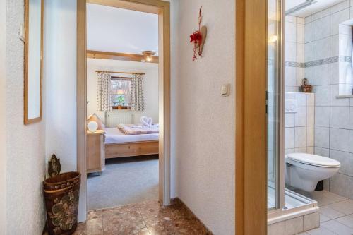 a bathroom with a toilet and a bedroom at Ferienwohnung Kagerhuber in Schönau am Königssee