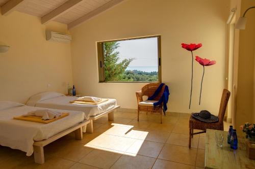 a room with two beds and a window with flowers at Villa Ippokampos Ideales Resort in Kefallonia
