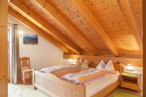 a bedroom with a bed in a wooden house at Ferienwohnung Kramer in Grainau