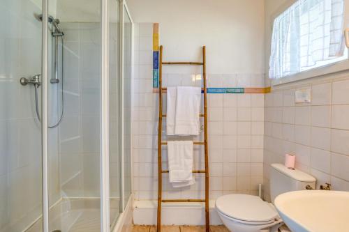 a bathroom with a shower and a toilet and a sink at Mas des Cypres - Mazet 4 in Saintes-Maries-de-la-Mer