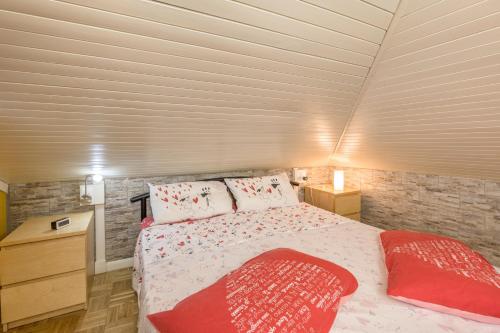 a bedroom with a large bed with red pillows at Residence Gigi Complex Manerba in Manerba del Garda