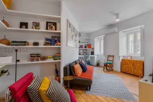 a living room with a couch and a chair at Casa Moura in Lisbon