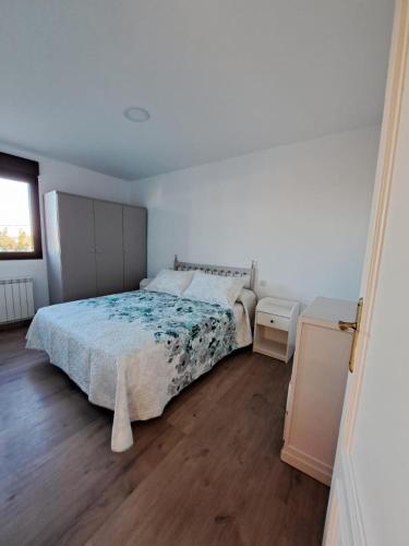 a bedroom with a bed and a wooden floor at Casa Pedro in Vélez-Rubio