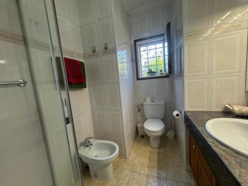 a bathroom with a toilet and a sink and a shower at Villa Rocamar in L'Escala
