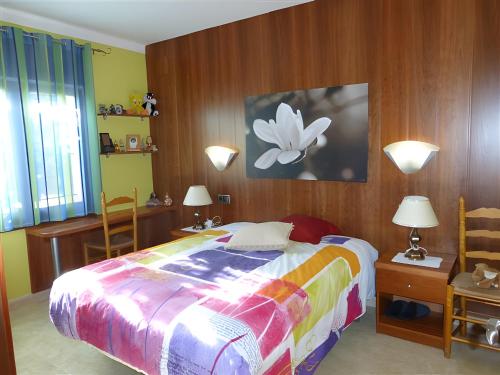 a bedroom with a bed and two tables and two lamps at Villa Rocamar in L'Escala