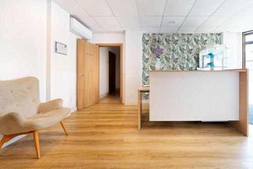 a living room with a table and a chair at R2 Cala Millor in Cala Millor
