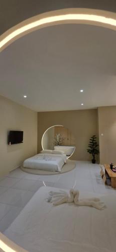 a bedroom with a large bed and a mirror at Ipoh Town Hotel by Serenity in Ipoh
