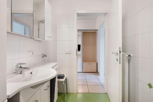 a white bathroom with a sink and a shower at Georgshof - Eppan in Appiano sulla Strada del Vino