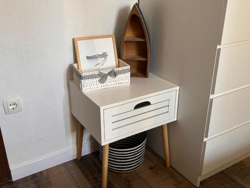 a white dresser with a shelf and a picture on it at "Ivanera" Postira otok Brač in Postira