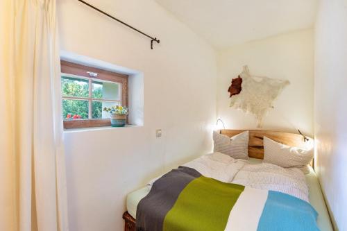 a bedroom with a bed and a window at Kammbühlhof in St. Blasien
