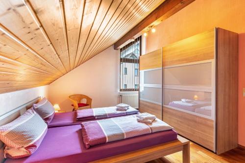 a bedroom with two beds and a large window at Marlene in Friesenheim