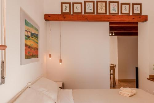 a bedroom with a bed and some pictures on the wall at Cantina Rustica in Montallegro