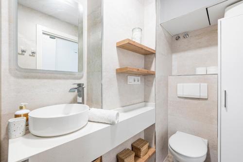 a bathroom with a sink and a toilet at Plazamar 044 in Torre del Mar