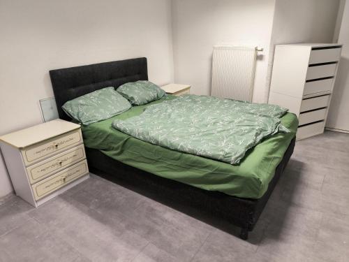 a bedroom with a bed with a nightstand and a bed sidx sidx sidx sidx at Ferienwohnung In Krumbach in Krumbach