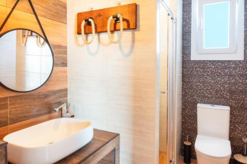 a bathroom with a sink and a mirror at Mont' Rock villas 3 in Posidhonía