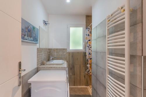 a bathroom with a toilet and a sink at Le Pequelet in Payzac