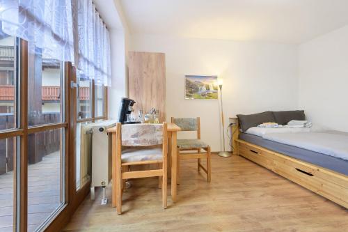 a bedroom with a bed and a desk with a chair at Ferienidyll Zwiesel in Zwiesel