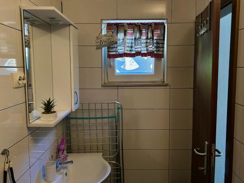 a bathroom with a sink and a mirror at "Ivanera" Postira otok Brač in Postira