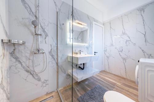 a bathroom with a shower and a sink at Kassiopi Apartment 2 in Kassiopi
