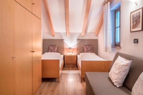 a small room with two beds and a couch at Lotschenhof Apt Tulpe in Trodena