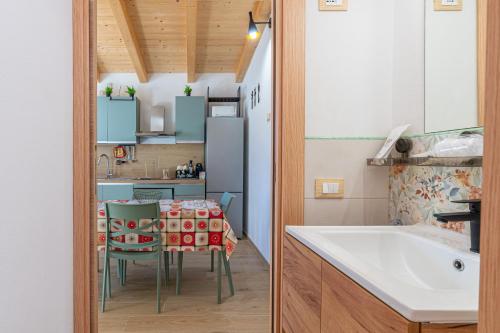 a kitchen with a table and a kitchen with blue cabinets at Baglio Netino in Noto
