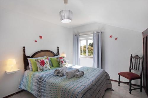 a bedroom with a bed with three gray elephants on it at Quinta das Andorinhas - Nazaré in Famalicão