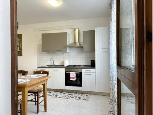 a kitchen with a table and a stove top oven at a due passi da Conegliano in Capo di Sotto