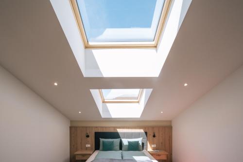 a bedroom with a bed and skylight at Balbeinhof Apt Gams in Luson