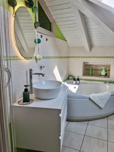a bathroom with a large tub and a sink at Villa Bella Vista in Zambrone