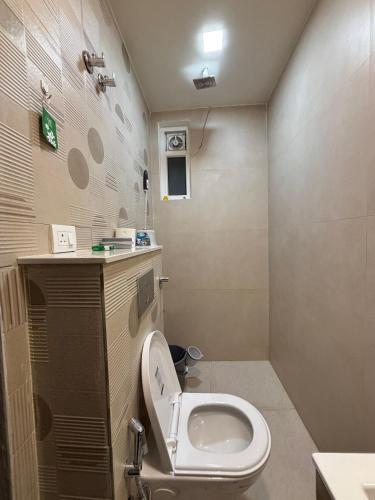 a bathroom with a toilet and a sink at The Bloomhouse inn in Rājpur