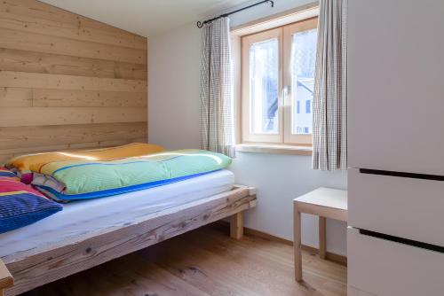 a small room with a bed and a window at Appartement Moosmann in Mellau