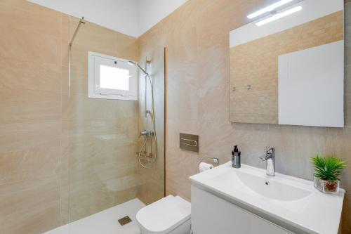 a bathroom with a toilet and a sink and a shower at Serenity in Arona