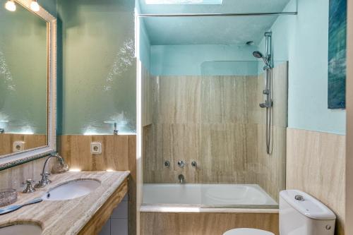 a bathroom with a tub and a sink and a toilet at Designer House With Panoramic views in Cadaqués