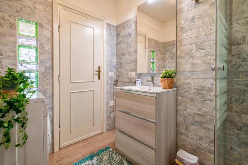 a bathroom with a sink and a shower at Endless Summer Apartment in Isola Rossa