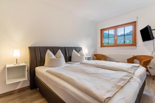 a bedroom with a large bed and a window at Haus Sum in Oberwolfach