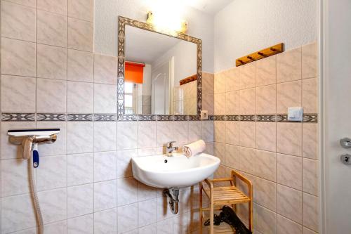 a bathroom with a sink and a mirror at Apartment Eulenhof 1 in Bordelum