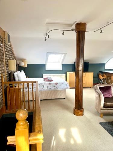 a bedroom with a bed and a table and a chair at The Ormond Apartments in Dungarvan