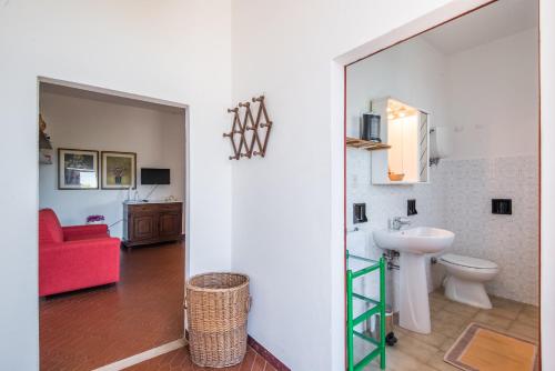 a bathroom with a sink and a toilet in a room at Podere del Pereto Bio- 201 in Rapolano Terme