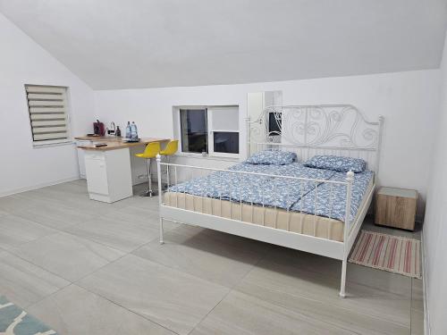 a bedroom with a bed and a desk in it at Studio M in Năsăud