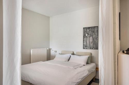 a bed with white sheets and pillows in a room at Ferienwohnung Zwei in Saal