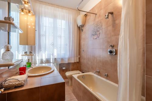 a bathroom with a tub and a sink at Casa Spazio Zero in Cantagrillo