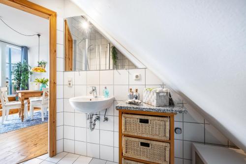 a bathroom with a sink and a mirror at Weitblick in Wesselburen