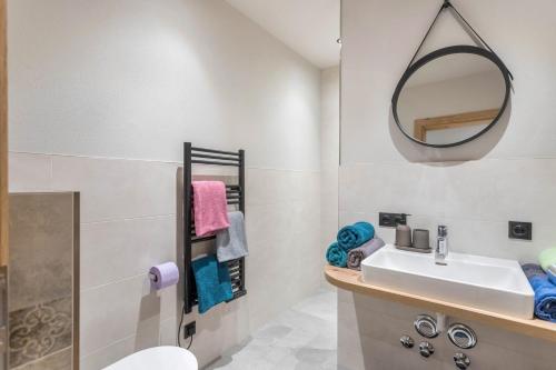a bathroom with a sink and a mirror at Luisalle Top 1 in Auffach
