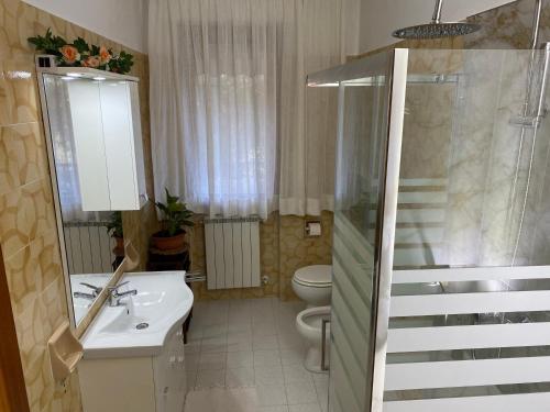 a bathroom with a sink and a toilet and a staircase at Casa Cesarina in Massa