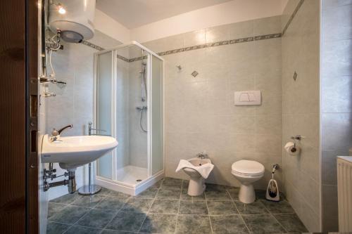 a bathroom with a sink and a shower and a toilet at Residence Lena App 3 with Balcony in Tenno
