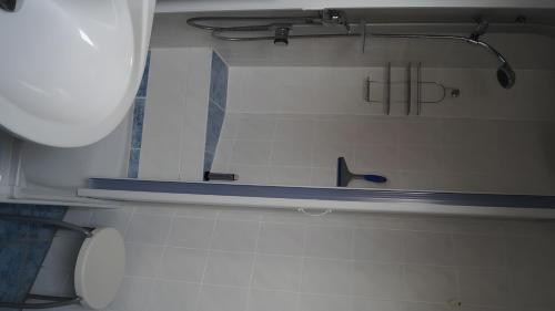 a bathroom with a toilet and a shelf on the wall at Fewo Hiddensee, 2 Personen 40 M² in Wiek auf Rügen