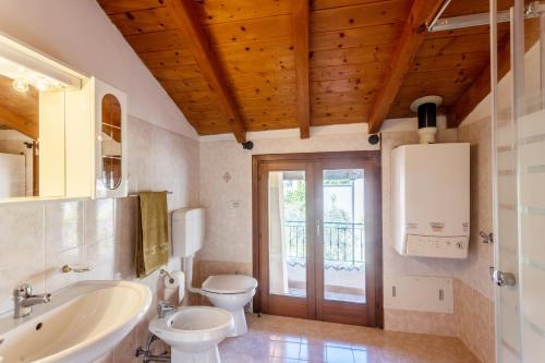 a bathroom with a white toilet and a sink at Casa Rita app 1 in Tremosine Sul Garda