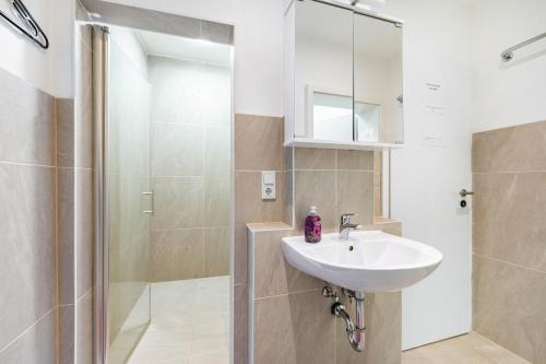 a bathroom with a sink and a shower at Saarglück - W4 in Beckingen