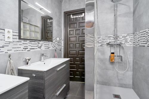 a bathroom with a shower and a sink and a mirror at Casa Beto in Almuñécar