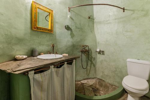 a bathroom with a sink and a toilet at Traditional Olive Guesthouse in Fállika